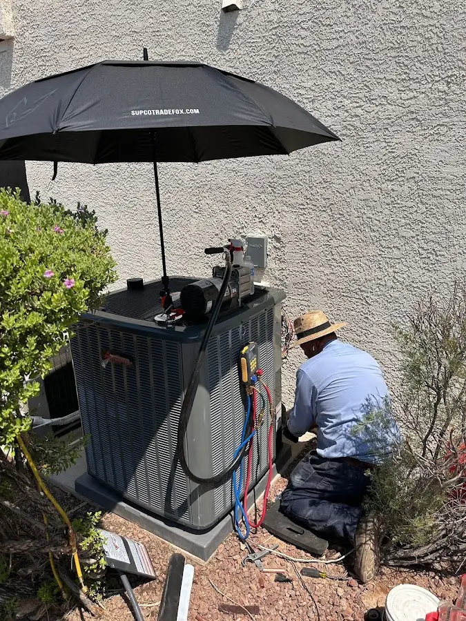 HVAC technician performing outdoor AC maintenance in Lower Oxford